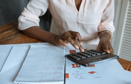Woman using a calculator at her desk